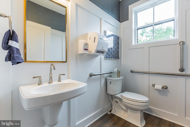 bathroom with wood-type flooring and toilet