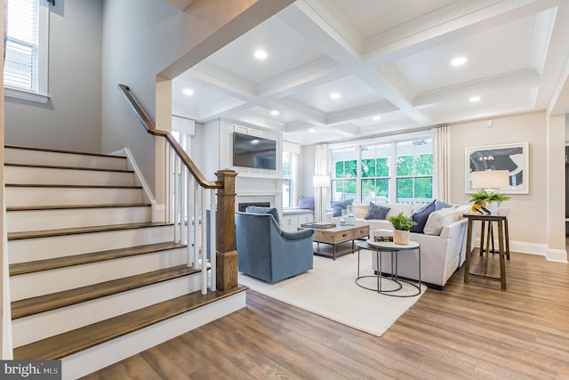 living room featuring light hardwood / wood-style flooring, beamed ceiling, and coffered ceiling