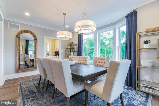 dining room with dark hardwood / wood-style flooring and ornamental molding