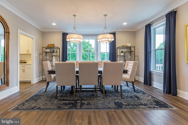 dining space with hardwood / wood-style flooring and crown molding