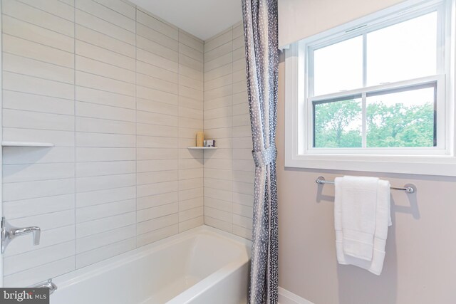 bathroom with shower / bath combo with shower curtain