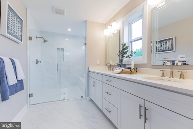 bathroom featuring vanity and a shower with shower door