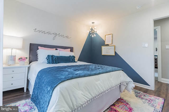 bedroom featuring dark hardwood / wood-style flooring and an inviting chandelier