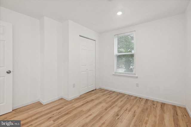 unfurnished room with light wood-type flooring