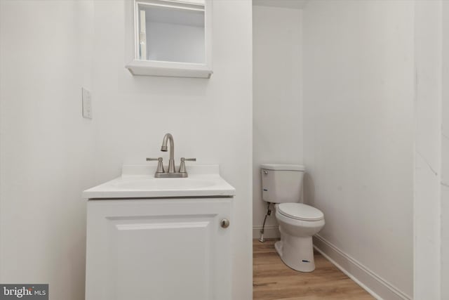 bathroom featuring vanity, toilet, and wood-type flooring