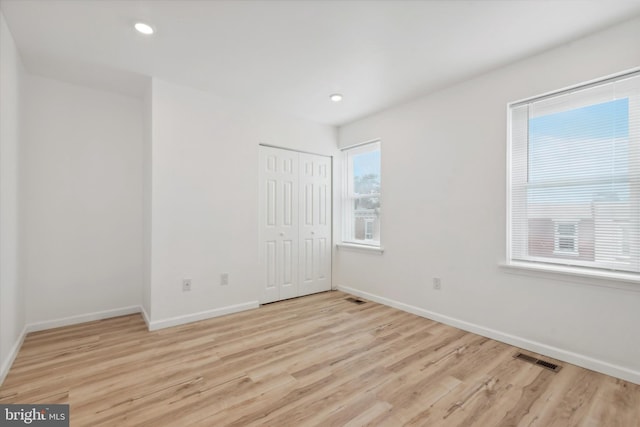 spare room with light hardwood / wood-style floors