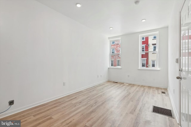 spare room with light hardwood / wood-style flooring