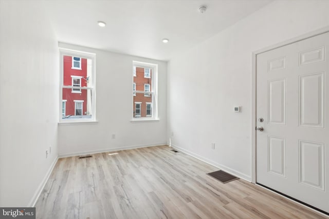 empty room featuring light hardwood / wood-style floors and a wealth of natural light