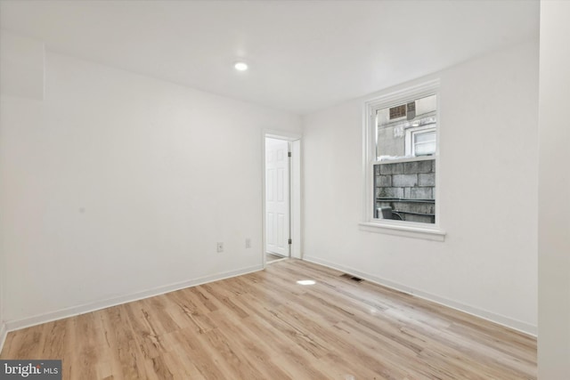 unfurnished room with light hardwood / wood-style flooring