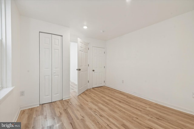 unfurnished bedroom with light wood-type flooring