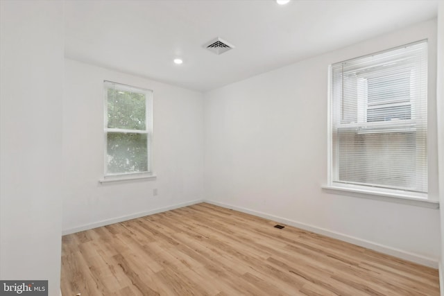 unfurnished room featuring light hardwood / wood-style floors