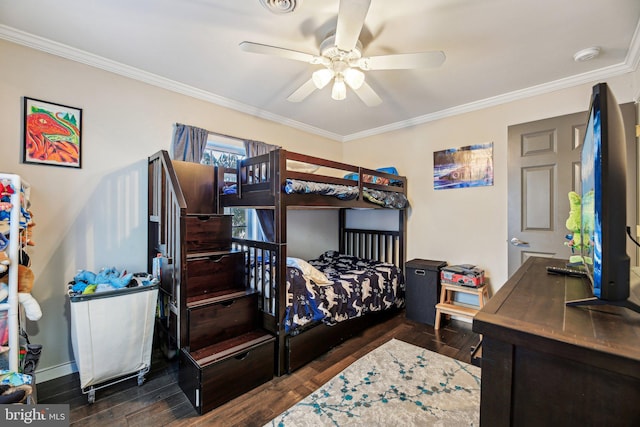 bedroom with ceiling fan, ornamental molding, and dark wood-type flooring