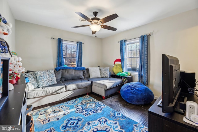 living room with ceiling fan and dark wood-type flooring