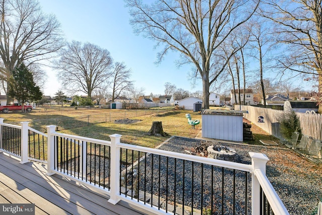 deck featuring a storage shed and a lawn