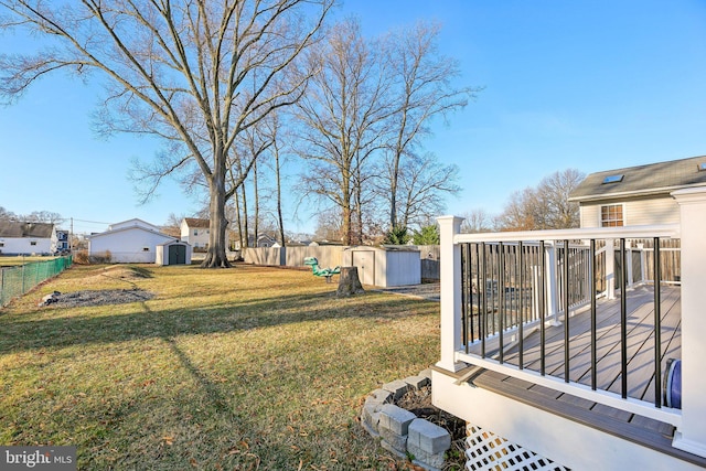 view of yard with a storage unit and a deck