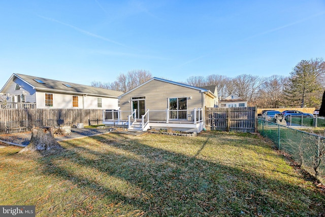 back of property featuring a yard and a wooden deck