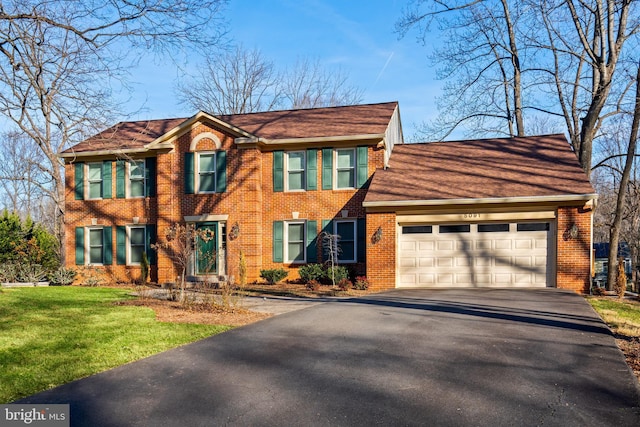 view of front facade featuring a garage and a front lawn