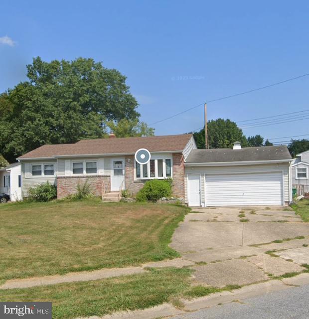 single story home with a front lawn and a garage