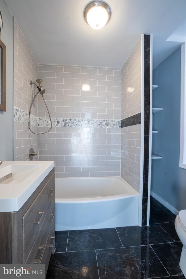 full bathroom with vanity, toilet, and tiled shower / bath