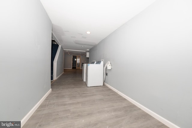 hall featuring washer / clothes dryer and light hardwood / wood-style flooring