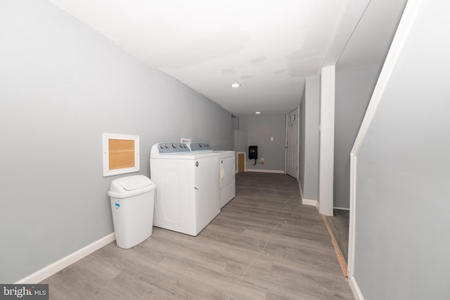 laundry room featuring light hardwood / wood-style floors and washing machine and dryer