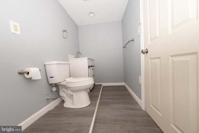 bathroom with hardwood / wood-style flooring, toilet, and lofted ceiling