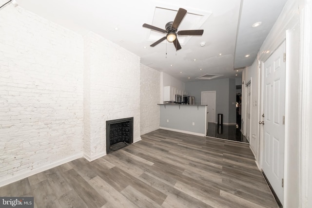 unfurnished living room with a fireplace, hardwood / wood-style floors, and ceiling fan