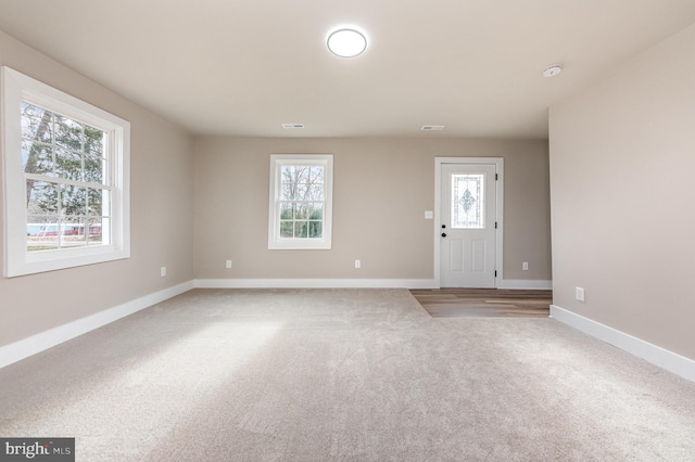 foyer featuring carpet flooring