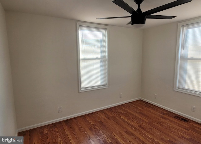 empty room featuring ceiling fan and dark hardwood / wood-style flooring