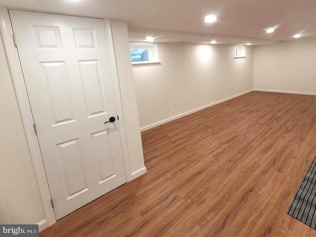 basement with hardwood / wood-style floors