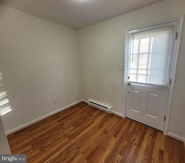 doorway to outside with baseboard heating and dark wood-type flooring