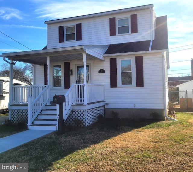 view of front facade featuring covered porch and a front yard