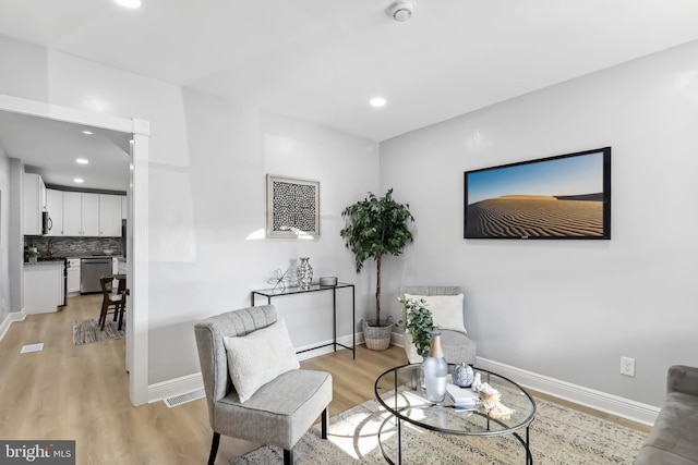 sitting room with light hardwood / wood-style floors