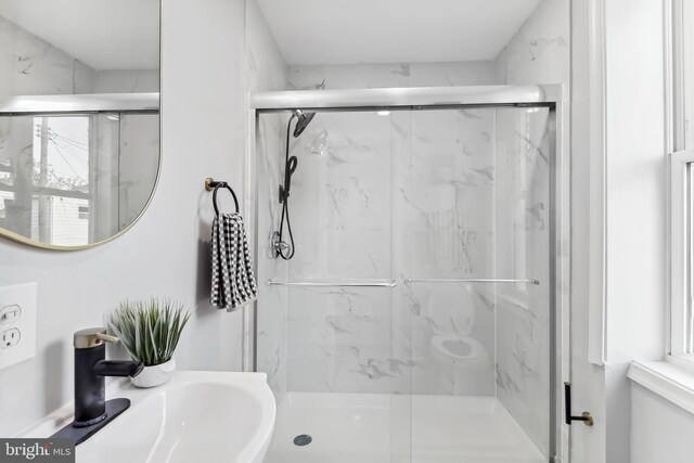 bathroom with an enclosed shower and sink