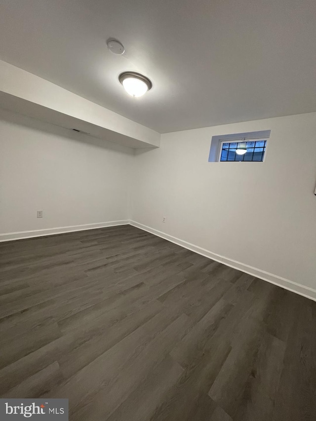 basement featuring dark hardwood / wood-style flooring