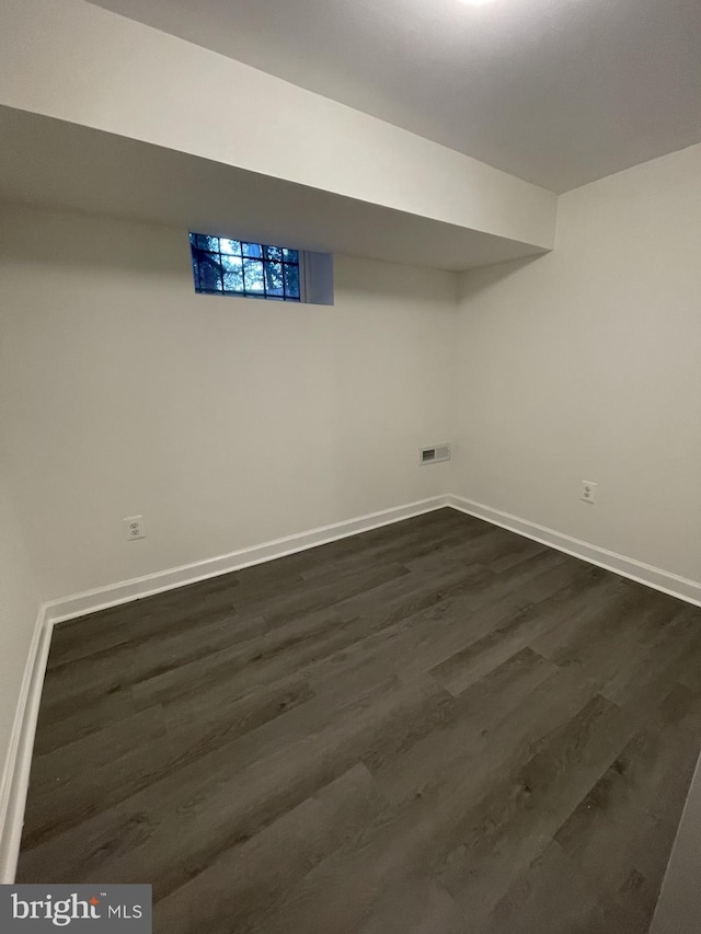 basement featuring dark hardwood / wood-style floors