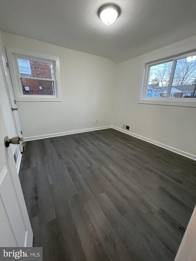 empty room with dark wood-type flooring