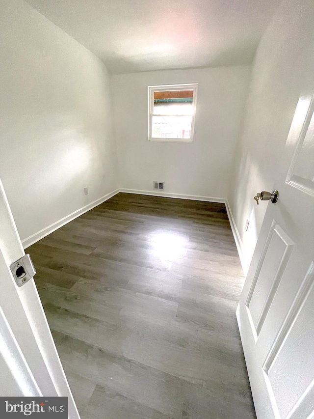 unfurnished room featuring dark hardwood / wood-style flooring