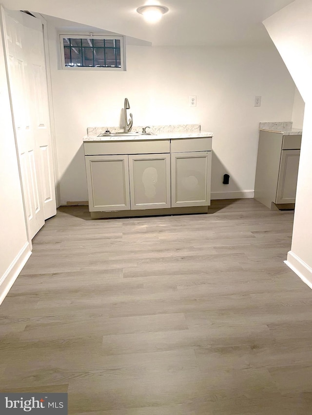 interior space with light wood-type flooring and sink