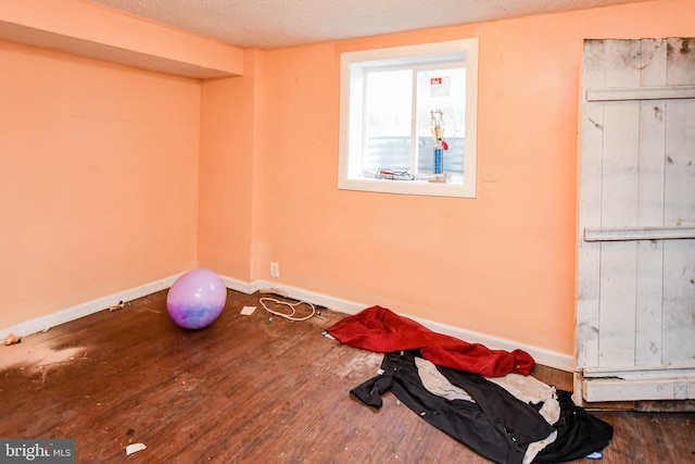 interior space with hardwood / wood-style floors and a textured ceiling