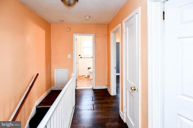 corridor with dark hardwood / wood-style flooring