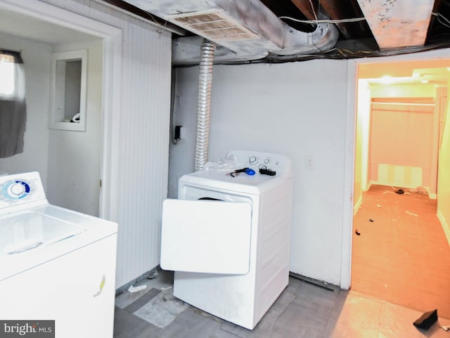 clothes washing area featuring washing machine and clothes dryer