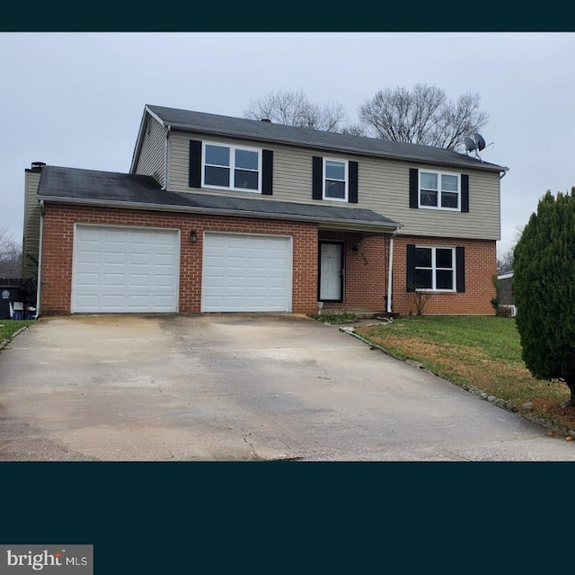 view of front of house featuring driveway, brick siding, and a front yard