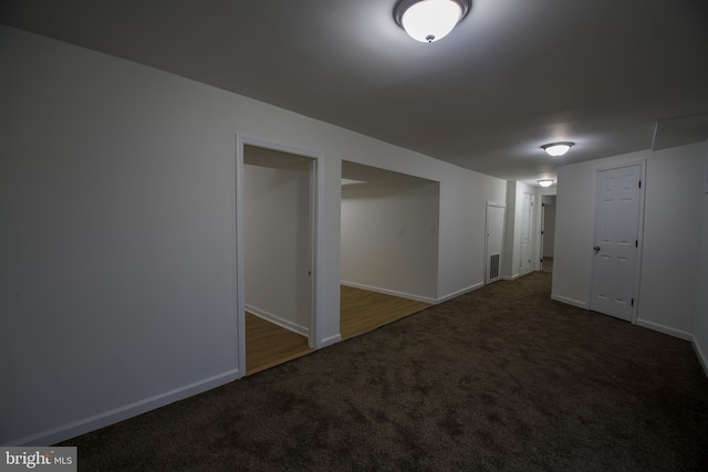 carpeted spare room with visible vents and baseboards