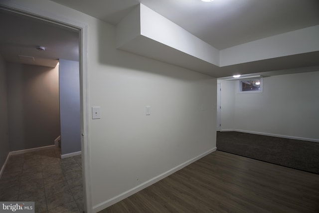 finished basement with baseboards and wood finished floors