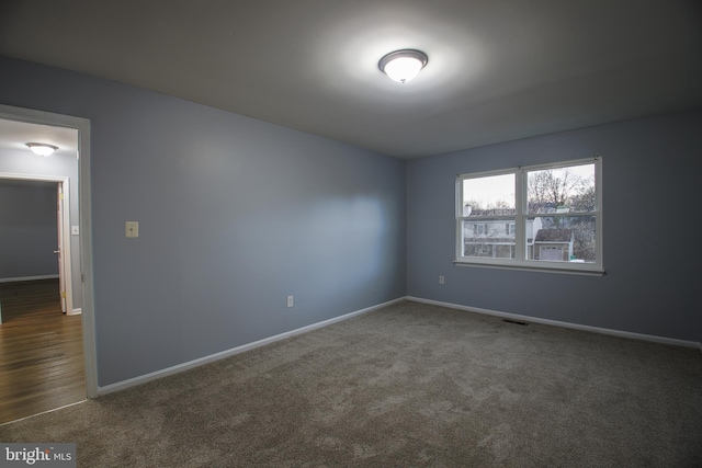 unfurnished room featuring baseboards and carpet flooring