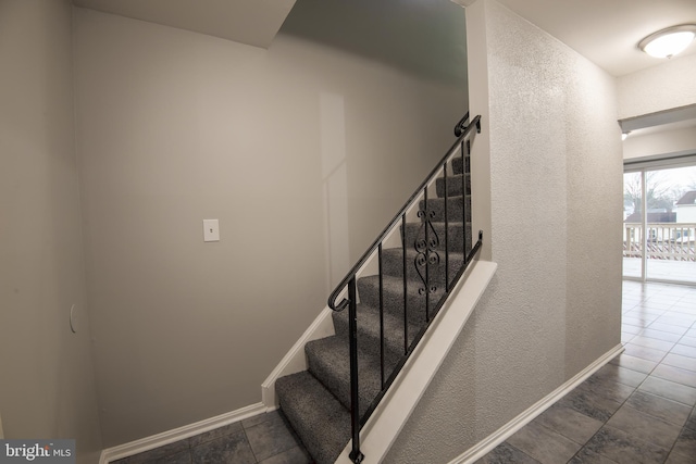 stairs featuring baseboards