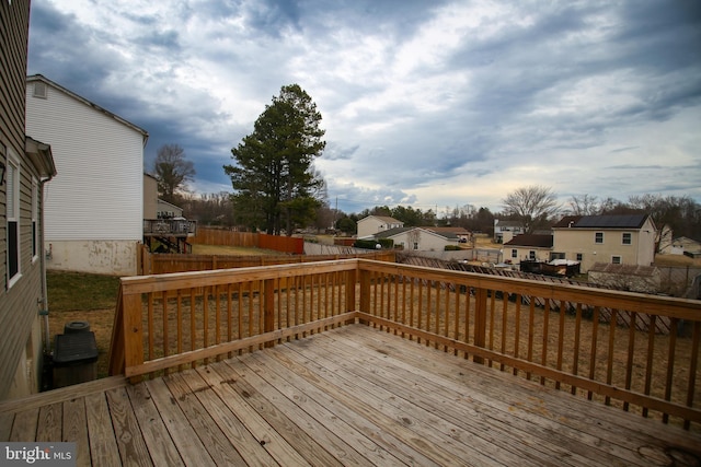 wooden deck with a residential view and fence