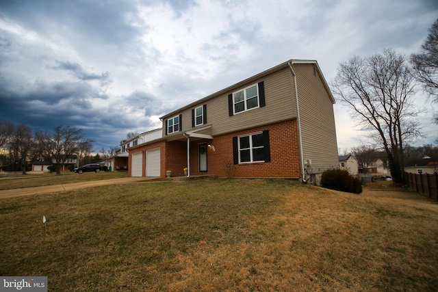 view of front of property featuring brick siding, concrete driveway, an attached garage, a front yard, and fence