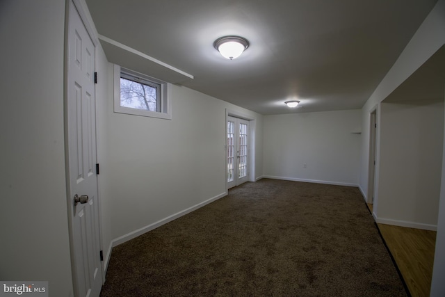 carpeted spare room with french doors and baseboards